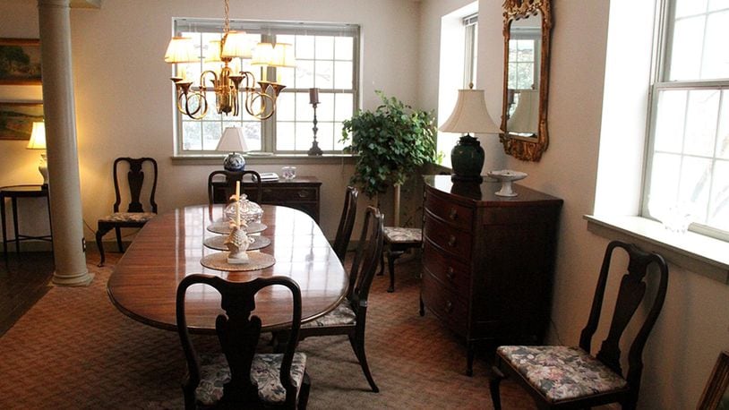 A brass chandelier centers the dining room, while recessed ceiling lights brighten the living room.