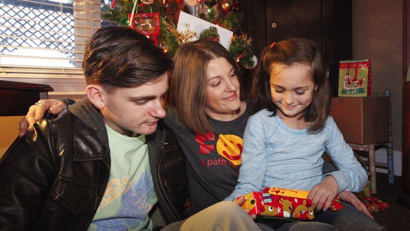 For the first holiday season in 13 years, Carlie Smith of Miamisburg was “able to be Santa” for her son Keaton, 16, and share Christmas morning with her daughter Lily, 8. “For all of my daughter’s and most of my son’s life, I was either battling to get clean or in active addiction,” Smith said. CHRIS STEWART / STAFF
