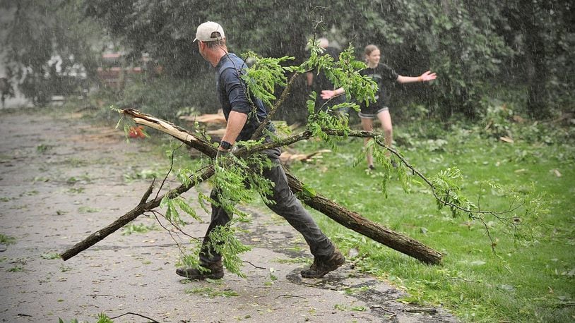Storms in Clark County Wednesday, June 8, 2022, knocked down several trees and damaged property, including homes and cars, on Lisa Court in Springfield. Neighbors came out after it was safe to help each other. MARSHALL GORBY/STAFF
