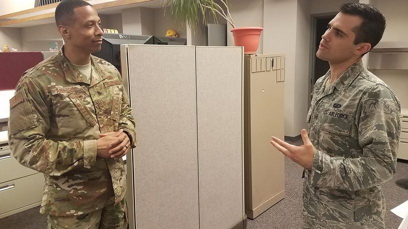 Second Lt. Evan Ewing (right), contracting specialist with the Air Force Life Cycle Management Center’s Installation Contracting Division, discusses policy with 2nd Lt. Thomas Anderson, also a contracting specialist with the division. (U.S. Air Force photo/Brian Brackens)