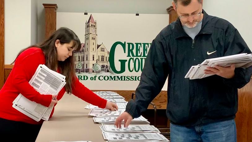 Workers at the Greene County Board of Elections match paper ballots Thursday afternoon. LONDON BISHOP/STAFF