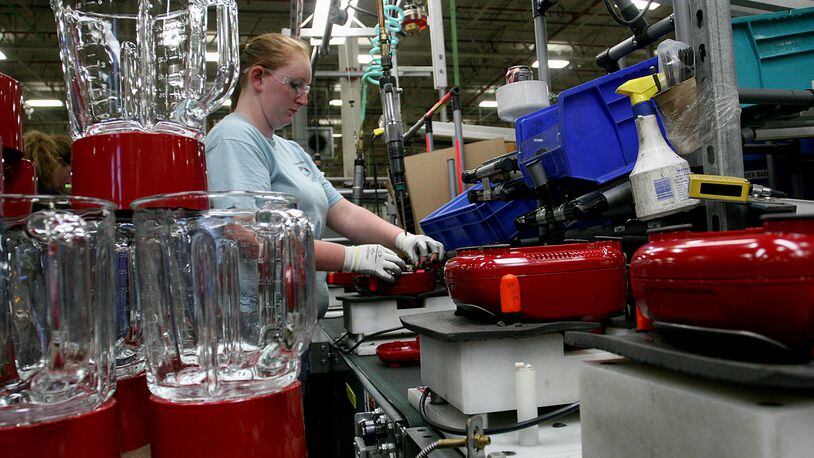 Whirlpool employee Elizabeth Riddle assembles the base for a stand-up mixer at the KitchenAid factory in Greenville in August 2012 in this file photo. FILE