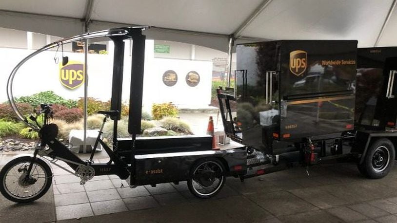 A UPS truck will drop off a trailer carrying four containers. The eBikes then hitch up an individual container and make deliveries. (Via KIRO7.com)