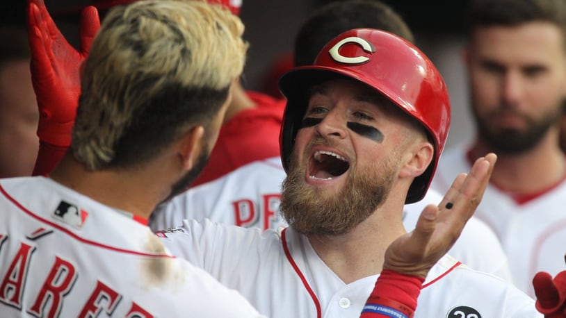 The Reds��� Tucker Barnhart celebrates with Eugenio Suarez after hitting a home run in the fourth inning against the Braves on Tuesday, April 23, 2019, at Great American Ball Park in Cincinnati. David Jablonski/Staff