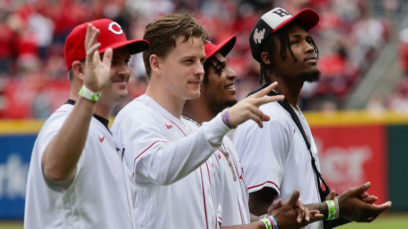 Bengals coach Zac Taylor, quarterback Joe Burrow and wide receivers Ja'Marr Chase and Tee Higgins are honored before the Reds' game against the Guardians on Opening Day on April 12, 2022, at Great American Ball Park in Cincinnati. David Jablonski/Staff