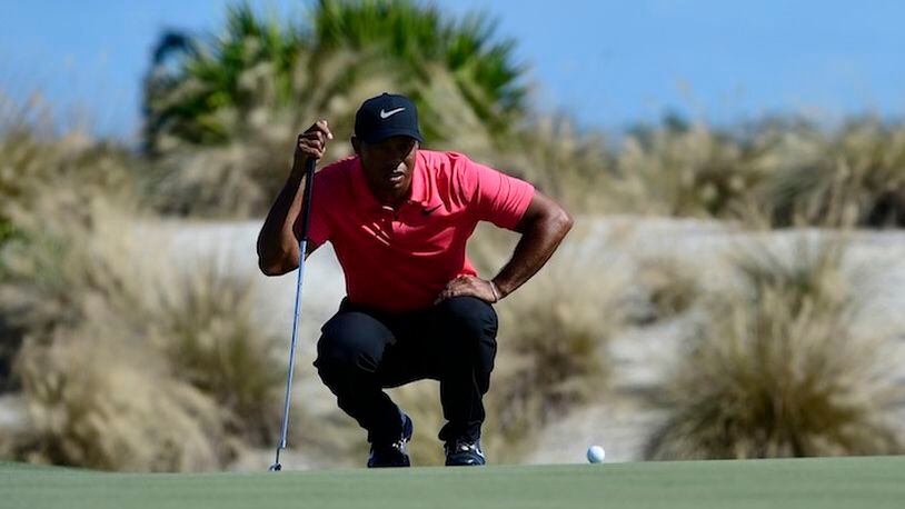 Tiger Woods plans his putt on second hole of the Hero World Challenge at Albany Golf Club in Nassau, Bahamas, Sunday, Dec. 3, 2017. (AP Photo/Dante Carrer)