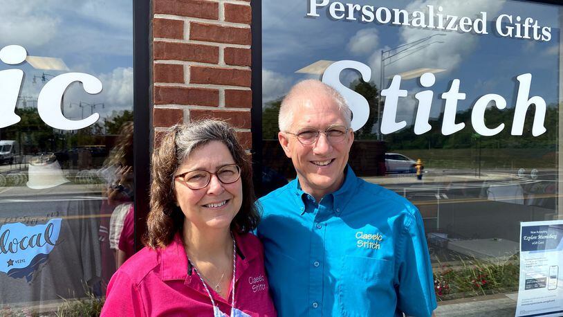 Shop owners Julie and Steve Grice standing outside of their Miamisburg store Classic Stitch.
