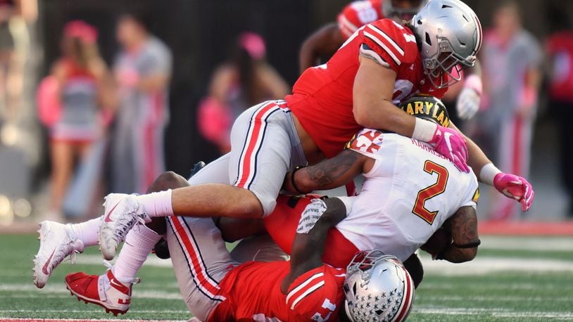 COLUMBUS, OH - OCTOBER 7:  Nick Bosa #97 of the Ohio State Buckeyes and Jerome Baker #17 of the Ohio State Buckeyes smother ballcarrier Lorenzo Harrison III #2 of the Maryland Terrapins in the second quarter at Ohio Stadium on October 7, 2017 in Columbus, Ohio.  (Photo by Jamie Sabau/Getty Images)