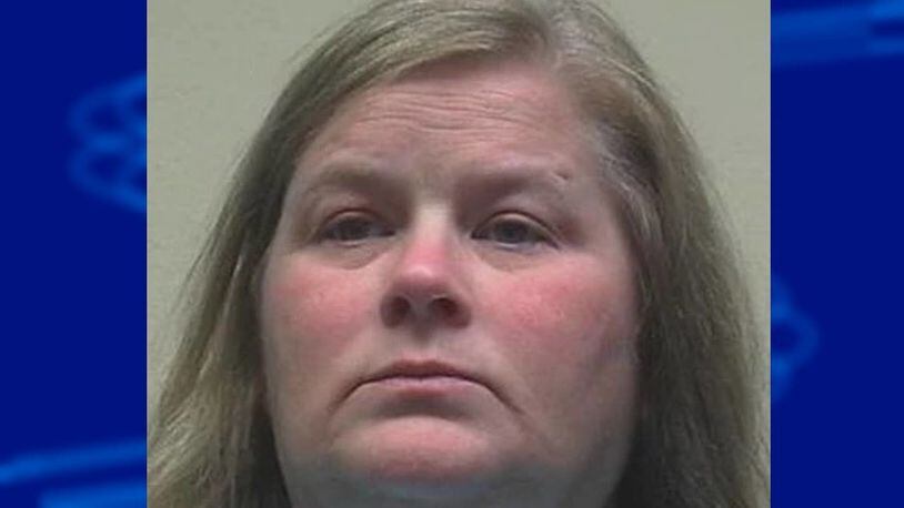 Sandra Lynn Henson surrendered to authorities Thursday. She is accused of crashing several weddings in northern Alabama and stealing gift cards.