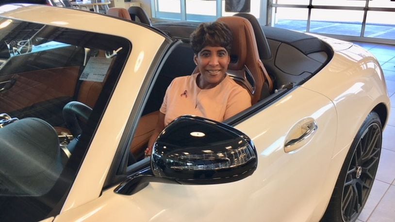 Jenell Ross, in a convertible in her Mercedes-Benz dealership on Loop Road in Centerville. Ross has run the Bob Ross Group of dealerships since the death of her father, Robert P. Ross Sr., in 1997. She is the sole second-generation African-American woman auto dealer in the country. THOMAS GNAU/STAFF