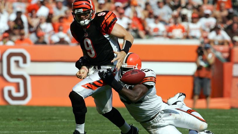 CLEVELAND - SEPTEMBER 11: Carson Palmer #9 of the Cincinnati Bengals fumbles the ball as he is tackled by Chaun Thompson #51of the Cleveland Browns during the third quarter at Cleveland Browns Stadium on September 11, 2005 in Cleveland, Ohio. The Bengals won 27-17. (Photo by Harry How/Getty Images)
