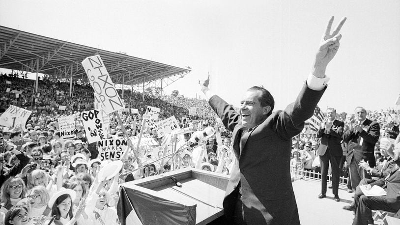 FILE - In this Sept. 19, 1968, file photo, then-presidential candidate Richard Nixon flashes the victory sign as he acknowledges cheers from the crowd, at the fairgrounds of Springfield, Mo. Theres little doubt Nixon was up to dirty tricks before his presidency ever began. Documents released by the Nixon Presidential Library add weight to existing evidence that his 1968 presidential campaign tried to sabotage Vietnam peace talks before the U.S. election. (AP Photo/File)