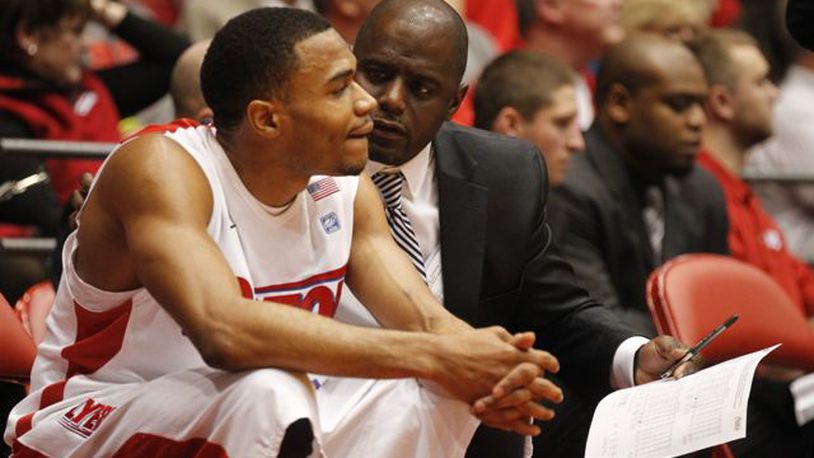 Dayton assistant coach Allen Griffin, right, talks to Vee Sanford on Sunday, Dec. 29, 2013, at UD Arena.