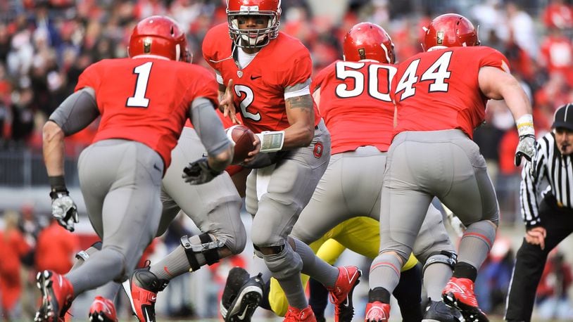 COLUMBUS, OH - NOVEMBER 27:  Quarterback Terrelle Pryor #2 of the Ohio State Buckeyes hands off against the Michigan Wolverines at Ohio Stadium on November 27, 2010 in Columbus, Ohio.  (Photo by Jamie Sabau/Getty Images)
