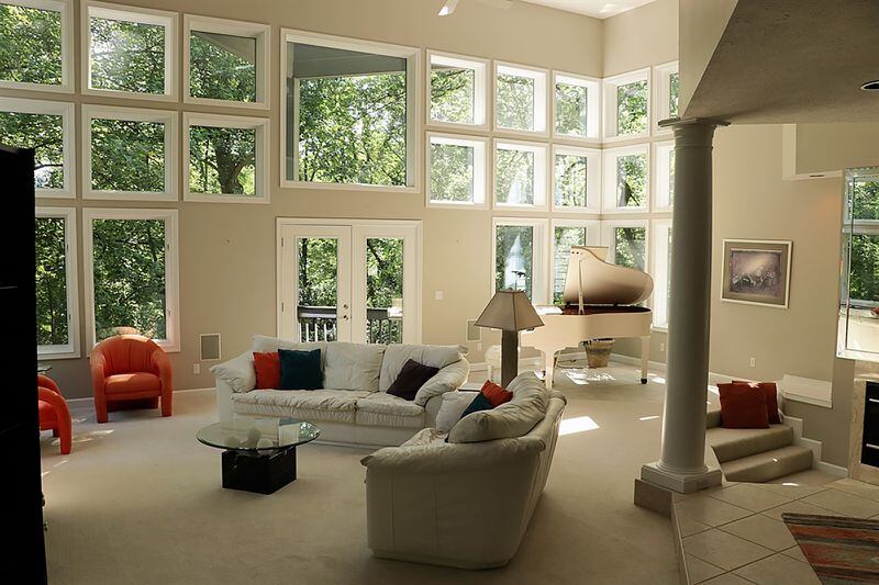 Windows are geometrically placed to fill three walls filling the entire first floor and loft with natural light while providing panoramic views of the surrounding woods. Glass doors open out from the living room to a triangular side deck. The conversation pit has built-in seats that surround the fireplace which has marble surround. CONTRIBUTED PHOTO BY KATHY TYLER
