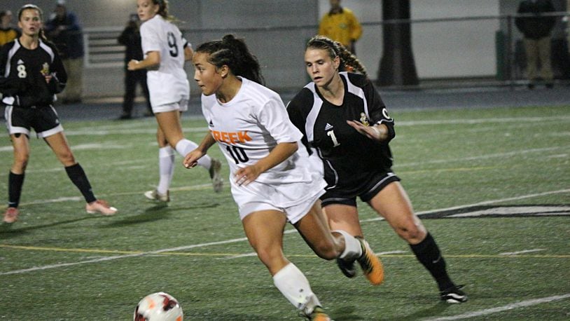 Beavercreek’s Diana Benigno (10) controls the ball as Centerville defender Julie Trouten (12) pursues during the Division I girls soccer sectional final Monday at Northmont High school. Contributed / Greg Billing