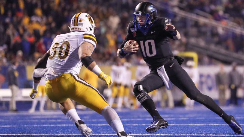 BOISE, ID - NOVEMBER 09: Quarterback Chase Cord #10 of the Boise State Broncos tries to avoid the tackle of linebacker Logan Wilson #30 of the Wyoming Cowboys during the second half on November 9, 2019 at Albertsons Stadium in Boise, Idaho. Boise State won the game 20-17 in overtime. (Photo by Loren Orr/Getty Images)