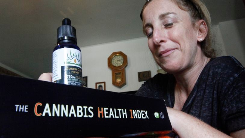 Lorrie Callahan of West Milton, who has multiple sclerosis, uses cannabidiol to control pain and is now an advocate for medical marijuana patients in Ohio. CHRIS STEWART / STAFF