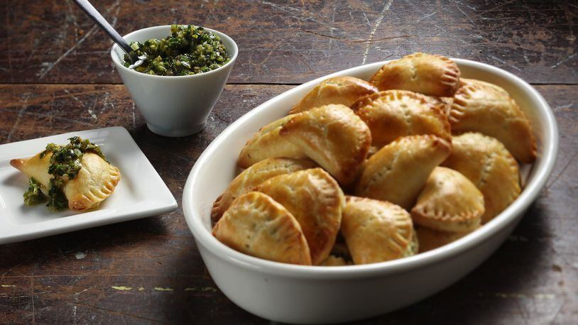 Cheese turnovers have cream cheese in the dough, plus a filling of farmer cheese, fresh arugula, ramps and dill. (Shannon Kinsella / food styling) (Abel Uribe/Chicago Tribune/TNS)