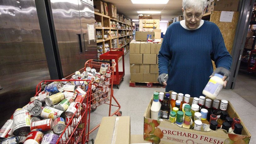 Gail Matson, board president of the Xenia Area Fish Food Pantry, with freshly restocked, donated canned goods. The pantry is seeking EDGE grant money from Greene County and other partners to relocate to a larger county-owned building in Xenia that would nearly triple the amount of space for the operation. TY GREENLEES / STAFF