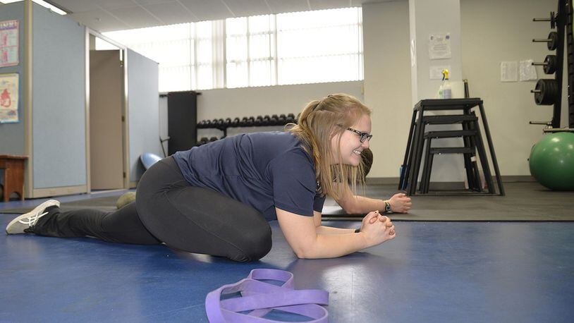 Hannah Kohne, a contractor at the 711th Human Performance Wing, Air Force Research Laboratory, Wright-Patterson Air Force Base, stretches as a part of the Function Bridge Fitness Study on Feb. 14th. The study is a 15-week program where participants have the oportunity to work with trainers to achieve their fitness goals. (U.S. Air Force photo/Airman 1st Class Emily Woodring)