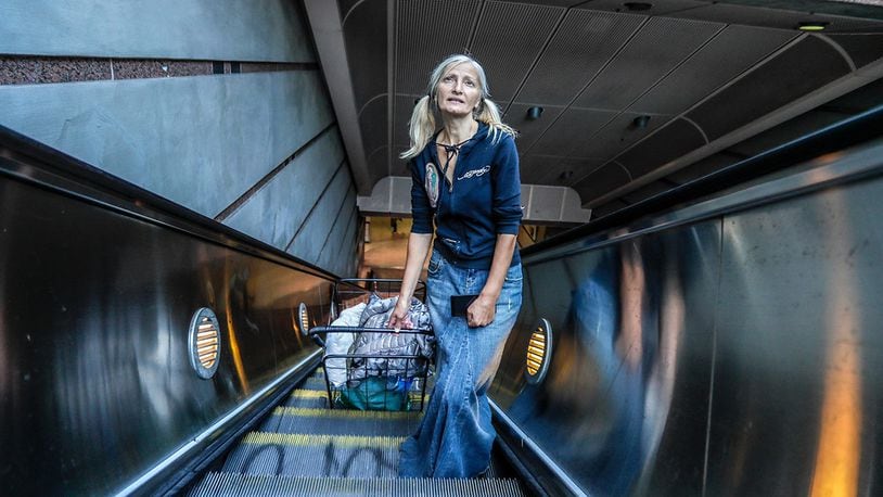 In this Monday, Sept. 30, 2019, photo, Emily Zamourka who is homeless emerges after singing from the Wilshire-Normandy subway station in Los Angeles.