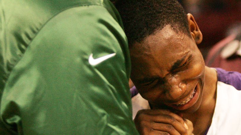 Thurgood Marshall’s Juwan Staten is comforted by Cleveland Cavalier star and Akron St. Vincent-St. Mary alum LeBron James following their 59-53 loss in the D-II state championship finals in 2009. Staff Photo by Jim Witmer