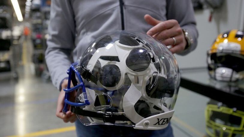 President of Xenith, Ryan Sullivan, points out different parts of a helmet at the Xenith factory Tuesday, April 25, 2017 in Detroit. Xenith makes high-tech football helmets, shoulder pads and other safety equipment. (Elaine Cromie/Detroit Free Press/TNS)