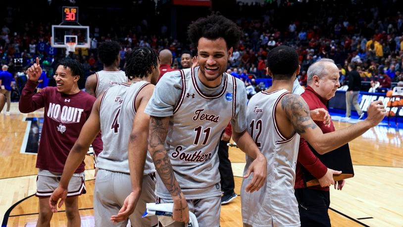 Texas Southern's Bryson Etienne, left, Jordan Gilliam, middle, and John Jones, right, celebrate the team's 76-67 win over Texas A&M-Corpus Christi in a First Four game in the NCAA men's college basketball tournament Tuesday, March 15, 2022, in Dayton, Ohio. (AP Photo/Aaron Doster)