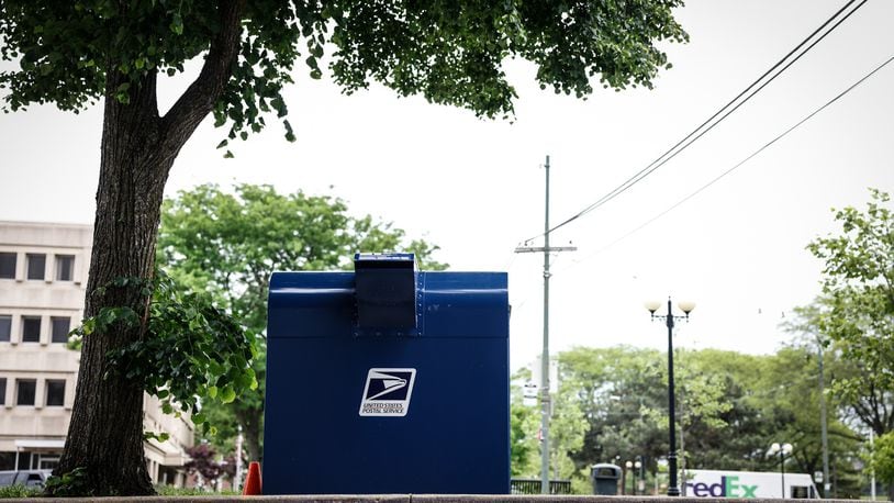 A postal box sits ready for use outside the U.S. postal service office on Fifth St. in Dayton. JIM NOELKER/STAFF