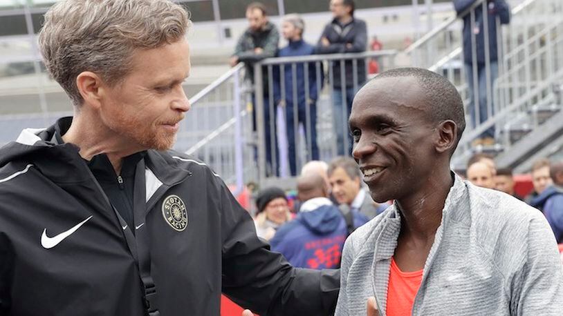 In this Saturday, May 6, 2017 file photo, Olympic marathon champion Eliud Kipchoge, right, talks with Nike CEO and President Mark Parker after crossing the finish line of a marathon at the Monza Formula One racetrack, Italy. Eliud Kipchoge was 26 seconds from making history on May 6. Nike and Adidas have announced separate plans to attack the 2-hour marathon, with both introducing shoe lines linked to the effort. Wireless tech giant Vodafone last month said it was backing a third bid, hoping data gleaned from the quest will translate into wearable technology. (AP Photo/Luca Bruno, File)