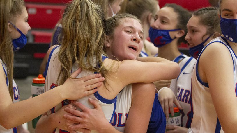 Carroll's Sarah Ochs (right) and Ava Lickliter hug as the Patriots celebrate their 57-48 victory over previously unbeaten Tippecanoe on Monday night at Tecumseh High School Jeff Gilbert/CONTRIBUTED