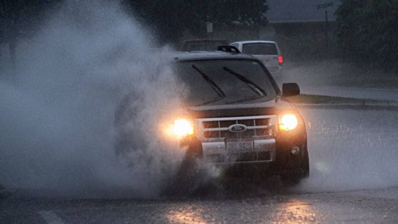 Montgomery County received over two inches of rainfall on Wednesday morning. On James H. McGee Blvd. in Dayton, this car deals with the massive puddles. MARSHALL GORBY/STAFF