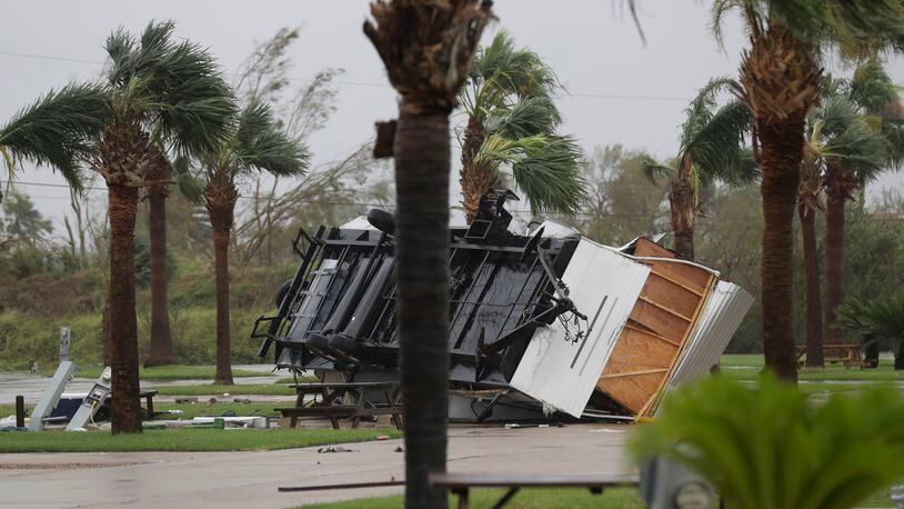 An overturned trailer sits in a park in the wake of Hurricane Harvey, Saturday, Aug. 26, 2017, in Aransas Pass, Texas.   Harvey rolled over the Texas Gulf Coast on Saturday, smashing homes and businesses and lashing the shore with wind and rain so intense that drivers were forced off the road because they could not see in front of them. (AP Photo/Eric Gay)