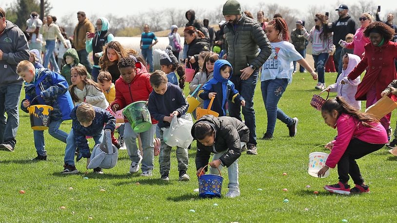 Hundreds of children race across the driving range at Young's Jersey Dairy picking up dyed hard boiled eggs during the annual Easter Egg Hunt Sunday, April 17, 2022. This was the 39th anniversary for the egg hunt at the dairy, however, it was the first time in two years it was held due to the COVID pandemic. This year Young's put out over 10,000 eggs for the children to collect. BILL LACKEY/STAFF