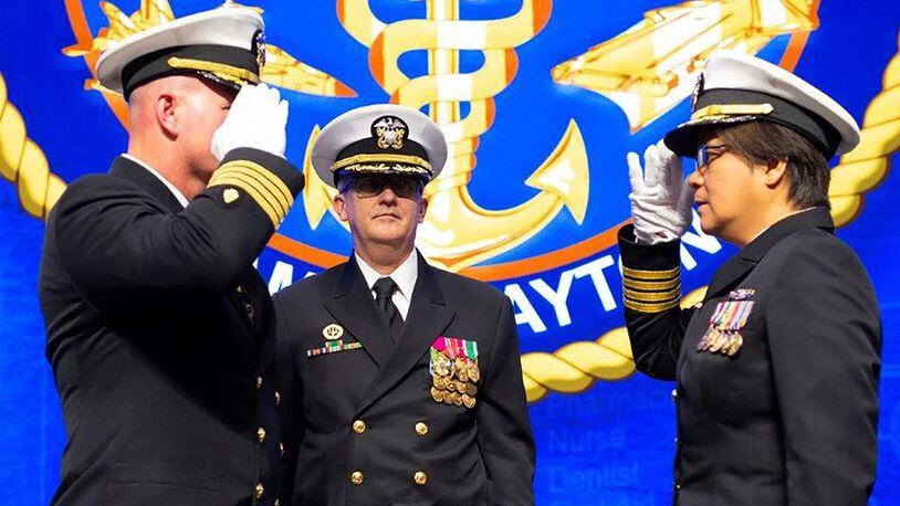 Capt. Adam Armstrong, commander, Naval Medical Research Center relieves Capt. Matthew Hebert from his role of NAMRU-Dayton’s commanding officer and turns command over to Capt. Nimfa Teneza-Mora during change of command ceremony. (U.S. Air Force photo/R.J. Oriez)