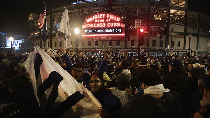 CHICAGO, IL - NOVEMBER 02: Chicago Cubs fans celebrate outside Wrigley Field after the Cubs defeated the Cleveland Indians in game seven of the 2016 World Series on November 2, 2016 in Chicago, Illinois. The Cubs 8-7 victory landed them their first World Series title since 1908. (Photo by Scott Olson/Getty Images)