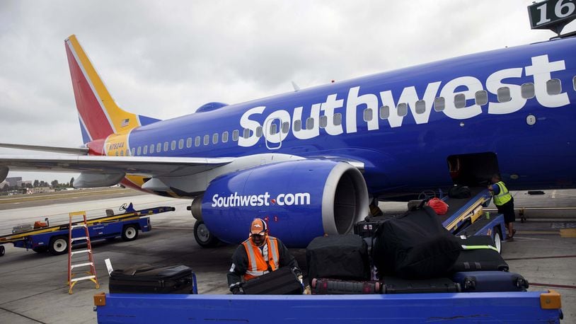 A ground operations employee loads baggage onto a Southwest Airlines aircraft at John Wayne Airport in Santa Ana, California, on April 14, 2016. PATRICK T. FALLON / BLOOMBERG MUST CREDIT