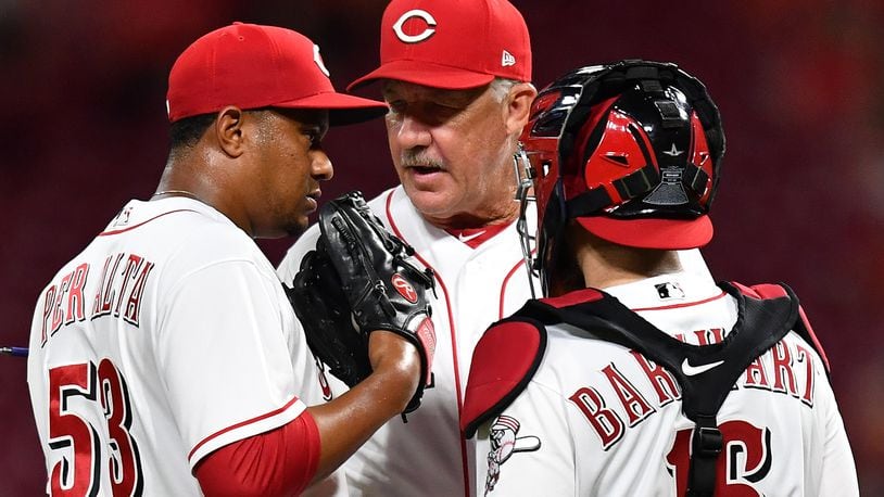 CINCINNATI, OH - JUNE 19: Pitching Coach Danny Darwin #52 of the Cincinnati Reds talks with pitcher Wandy Peralta #53 of the Cincinnati Reds and catcher Tucker Barnhart #16 of the Cincinnati Reds on the mound in the ninth inning against the Detroit Tigers at Great American Ball Park on June 19, 2018 in Cincinnati, Ohio. Cincinnati defeated Detroit 9-5. (Photo by Jamie Sabau/Getty Images)