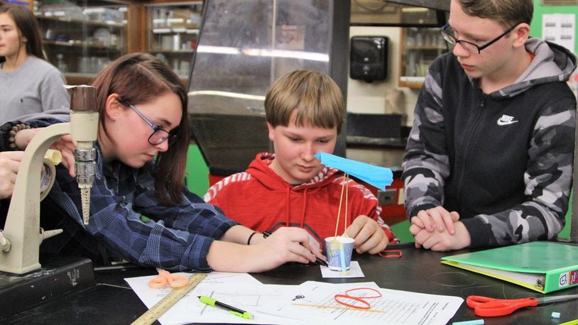 Greenon Junior High School students Riley Hrovatic, Christopher Kahlert and Jordan Gregory work on a project during an 8th-grade STEM class on Friday. HASAN KARIM/ STAFF