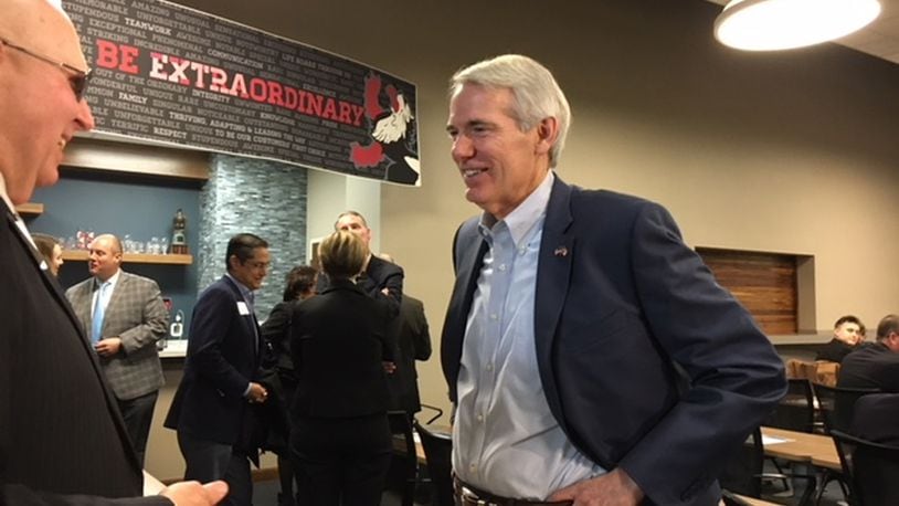 U.S. Sen. Rob Portman, center, talks with a guest at a Dayton Area Chamber of Commerce briefing Friday morning at Heidelberg Distributing’s Moraine distribution center. THOMAS GNAU/STAFF