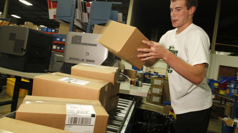 A shipping employee for Lastar — the predecessor company to C2G — packages boxes in this 2010 photo.