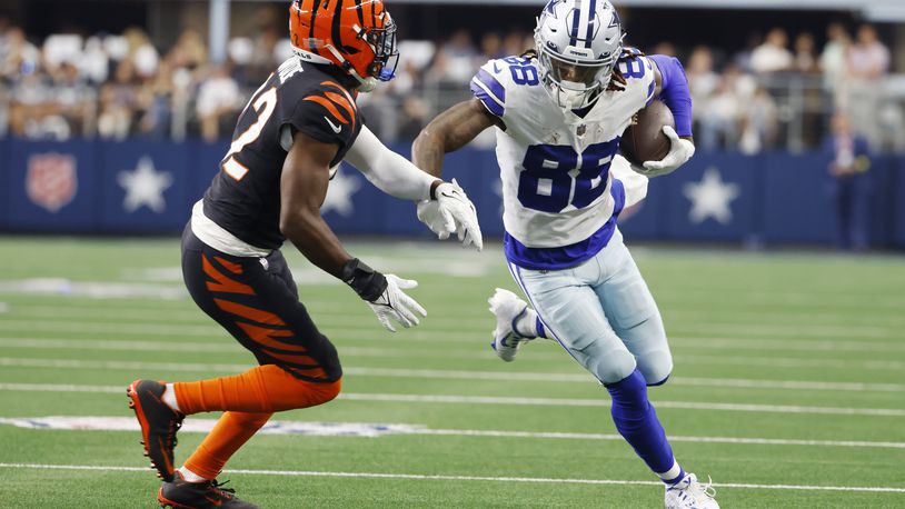 Dallas Cowboys wide receiver CeeDee Lamb (88) looks for yardage after a catch as Cincinnati Bengals cornerback Chidobe Awuzie (22) closes in during the first half of an NFL football game Sunday, Sept. 18, 2022, in Arlington, Tx. (AP Photo/Ron Jenkins)