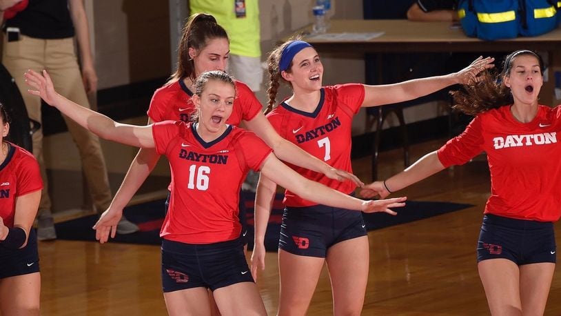 Dayton volleyball players celebrate a point in a match against Ohio on Aug. 29, 2017, at the Frericks Center. Photo by Erik Schelkun