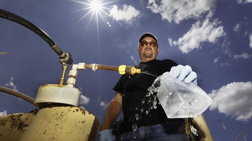 Don Day, a water lab technician with the City of Dayton, takes a sample from one of 200 monitoring wells used to check on the quality of water in the Great Miami Buried Valley Aquifer and test for any contaminants on a regular basis. CHRIS STEWART / STAFF