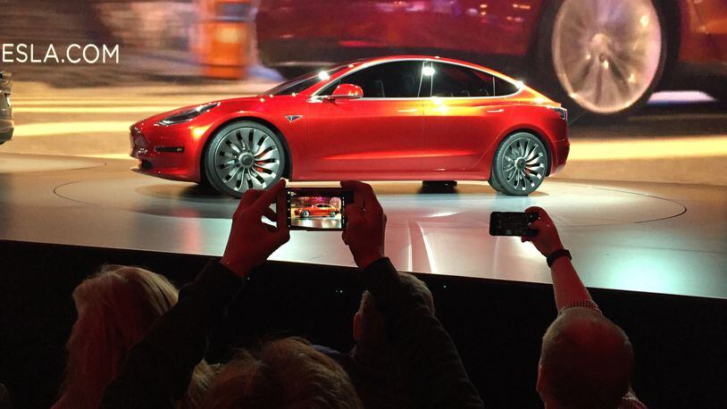 In March 2016, Tesla Motors unveiled the new lower-priced Model 3 sedan at a design studio in Hawthorne, Calif. More than 276,000 people pre-ordered the Model 3 in less than a week. (AP Photo/Justin Pritchard)