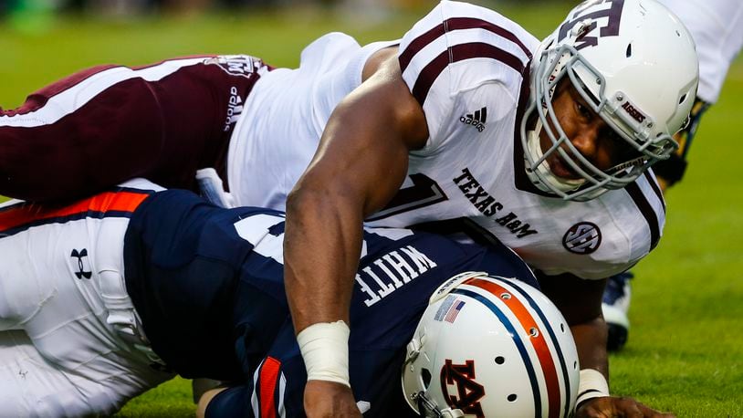 AUBURN, AL - SEPTEMBER 17: Quarterback Sean White #13 of the Auburn Tigers is sacked by defensive lineman Myles Garrett #15 of the Texas A&M Aggies during an NCAA college football game on September 17, 2016 in Auburn, Alabama. (Photo by Butch Dill/Getty Images)