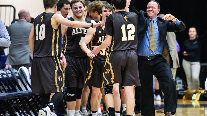 The Alter Knights react after beating Badin 60-51 in a Division II sectional final Tuesday night at Fairmont’s Trent Arena. NICK GRAHAM/STAFF