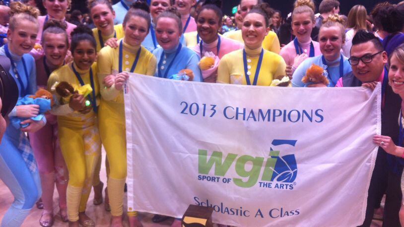 The Bellbrook winter guard team stands behind their championship trophy.