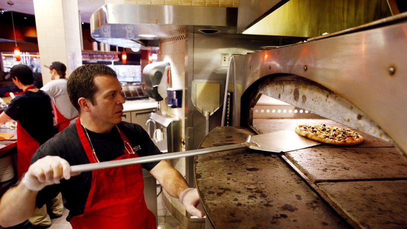 Owner Glen Brailey of Spinoza's Pizza prepares pizza dough at the restaurant inside the Mall at Fairfield Commons.